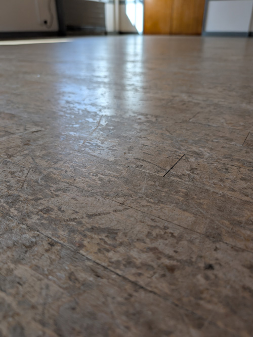 Worn oak church hall floor Preston - before
